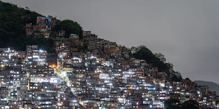 A Brazilian favela at night, highlighting dense urban living.