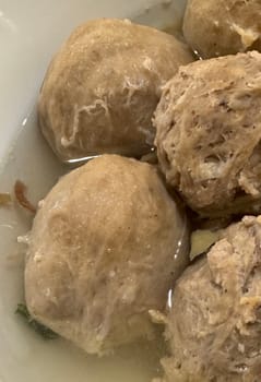 super delicious, tender and juicy and spicy bites of beef tendon meatballs in a bowl in Indonesian street food