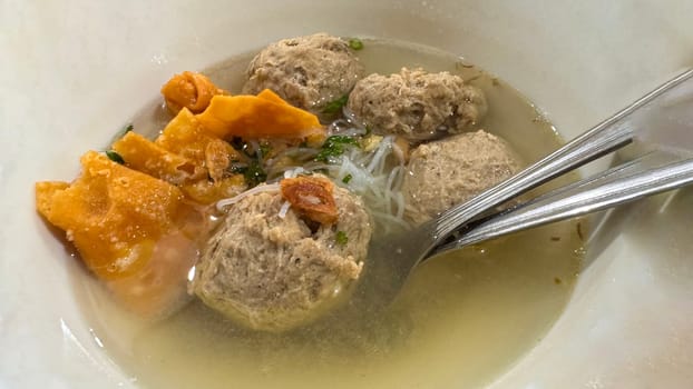 super delicious, tender and juicy and spicy bites of beef tendon meatballs in a bowl in Indonesian street food