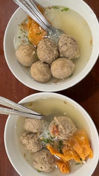 super delicious, tender and juicy and spicy bites of beef tendon meatballs in a bowl in Indonesian street food