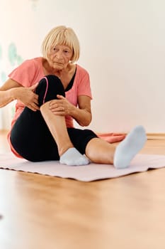 In a sunlit space, a senior woman gracefully practices rejuvenating yoga, focusing on neck, back, and leg stretches, embodying serenity and well-being.