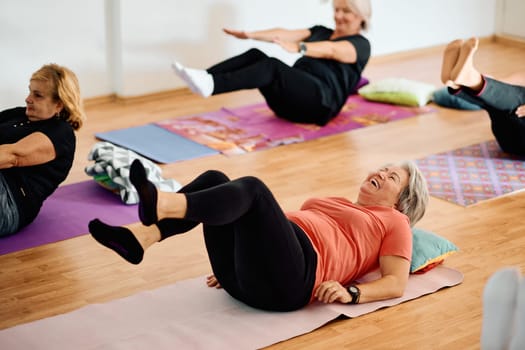 A group of senior women engage in various yoga exercises, including neck, back, and leg stretches, under the guidance of a trainer in a sunlit space, promoting well-being and harmony.