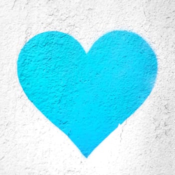Azure heart on wall. Azure love heart hand drawn on grungy wall. Textured background trendy street style.
