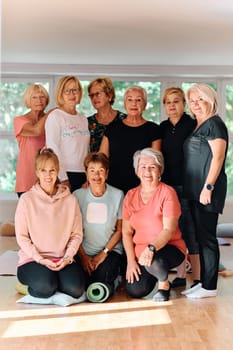 A vibrant community of senior women, guided by their instructor, embraces the enriching journey of yoga, fostering unity, well-being, and a shared commitment to active aging.