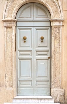 doors of Rome. Classic old wooden door in a public place on a city street or in an urban environment.