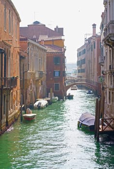 Venice colorful corners with iron bridges, old buildings and architecture, boats and beautiful water reflections on narrow canal, Italy