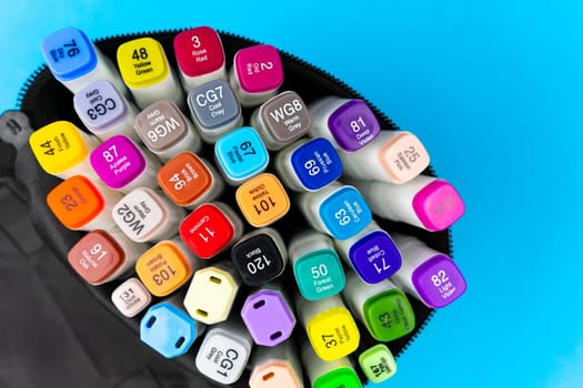 Many liners in a black purse on a blue background. Close-up of the liners in the purse