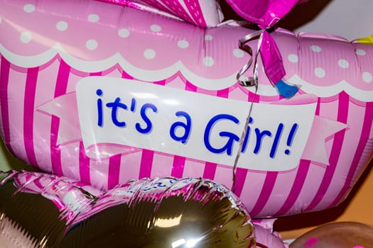 It's a girl. Bright pink balloon close-up.