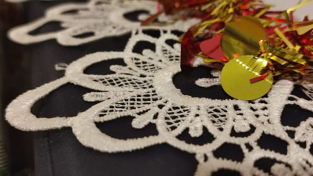 red and yellow Christmas garland, white lace tablecloth. High quality photo