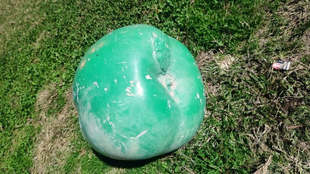 green apple art object on the grass. High quality photo