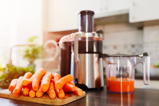 A kitchen scene with fresh carrots on a cutting board and a juicer filled with carrot juice, highlighting healthy lifestyle choices.
