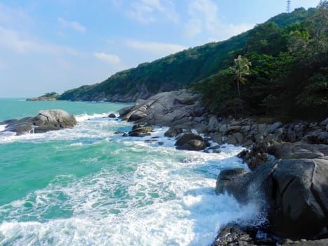 Beautiful coast with azure water cliffs and green jungle on Koh Phangan. Thailand