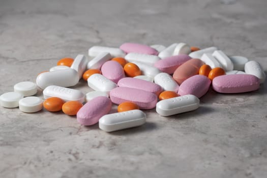 multicolored medical pills and packs of pills on a table.