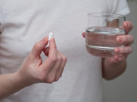 Close up of woman taking in pill, Medicine, health care and people concept