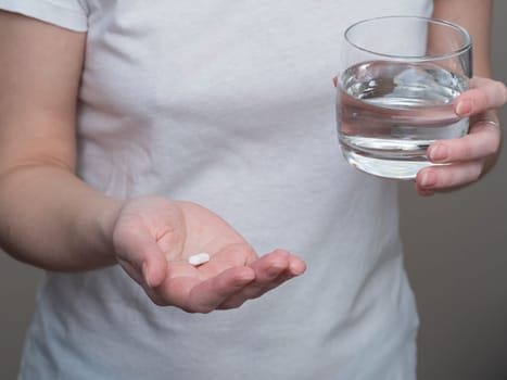 Close up of woman taking in pill, Medicine, health care and people concept