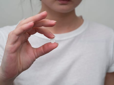 Close up of woman taking in pill, Medicine, health care and people concept