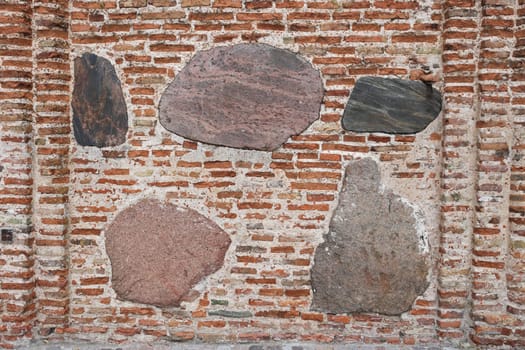 Abstract background from a wall with bricks and stones.