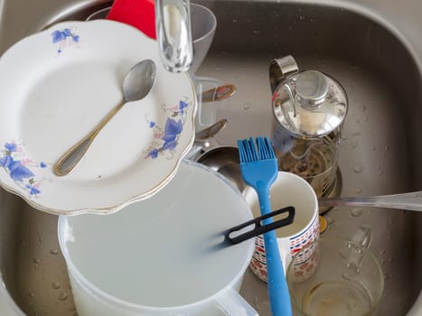 Pile of dirty dishes in the sink