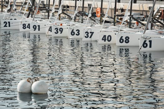 Monaco, Monte-Carlo, 18 October 2022: many sailing boats of the World Championship of J70 class participants stand in a row waiting for the wind for the stage of the sailing race. High quality photo