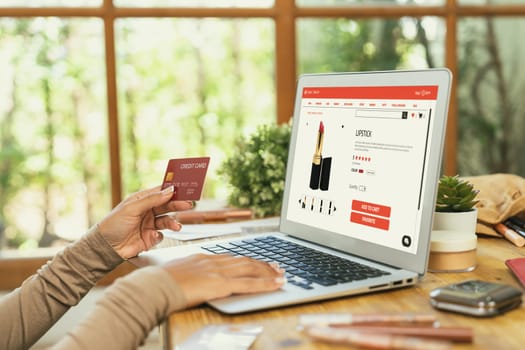 Woman shopping online on internet marketplace browsing for sale items for modern lifestyle and use credit card for online payment from wallet protected by crucial cyber security software