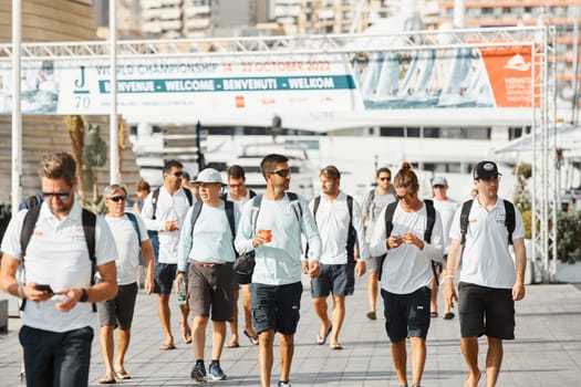 Monaco, Monte-Carlo, 18 October 2022: a group of yachtsmen participating in the upcoming sailing race goes to the yacht club, teams from different countries, the World Championship of J70 class. High quality photo