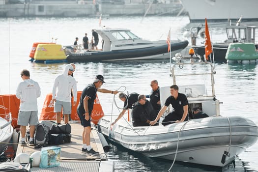Monaco, Monte-Carlo, 18 October 2022: teams from different countries are preparing a sailing boat for the upcoming regatta stage of the World Championship of J70 class, boats moored in new Yacht Club. High quality photo