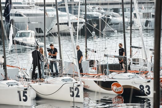 Monaco, Monte-Carlo, 18 October 2022: the film crew interviews the organizer of the regatta on board the boat, the upcoming regatta stage of the World Championship of J70 class, new Yacht Club. High quality photo