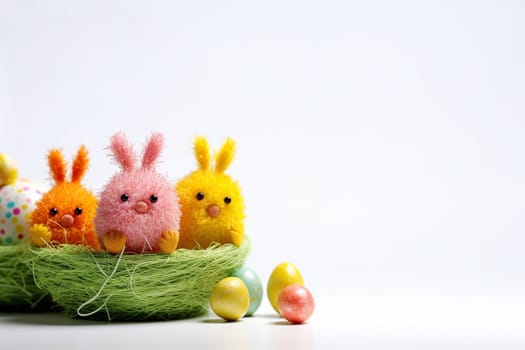 Colorful Easter bunnies and eggs in a nest on white background.