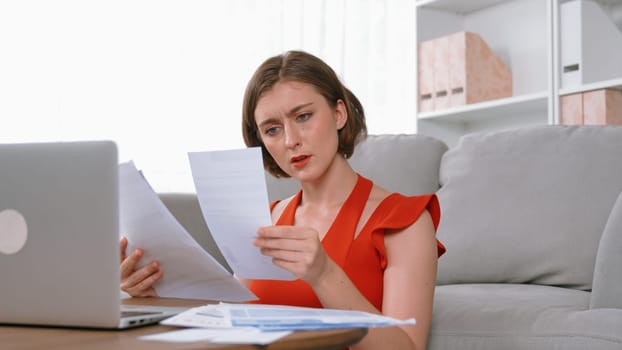 Stressed young woman has financial problems with credit card debt to pay prim from bad personal money and mortgage pay management crisis. Woman worry about financial bankruptcy risk from over spending