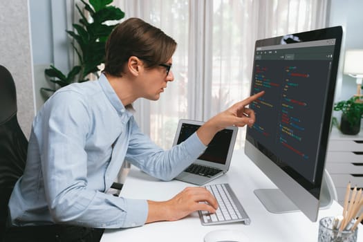 IT developer selecting by point on coding online software development information on pc comparing with laptop screen of new code program's update version firmware overall system project. Pecuniary.