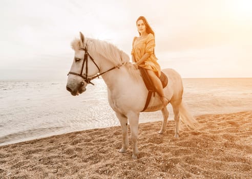 A woman in a dress stands next to a white horse on a beach, with the blue sky and sea in the background