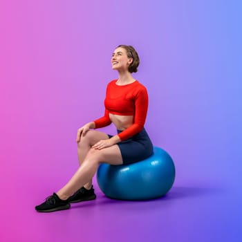 Full body length gaiety shot athletic and sporty young woman with fitness exercising ball in standing posture on isolated background. Healthy active and body care lifestyle.