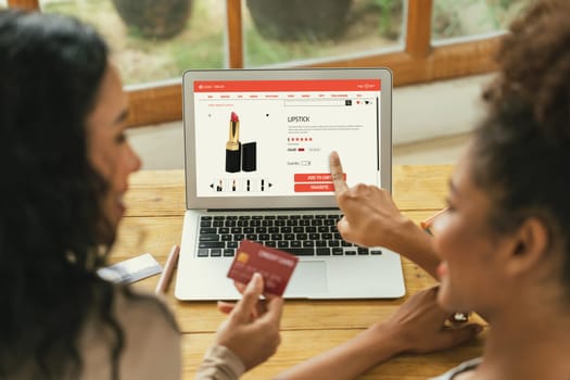 Woman shopping online on internet marketplace browsing for sale items for modern lifestyle and use credit card for online payment from wallet protected by crucial cyber security software