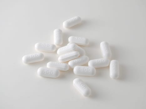 white medical tablets over white.