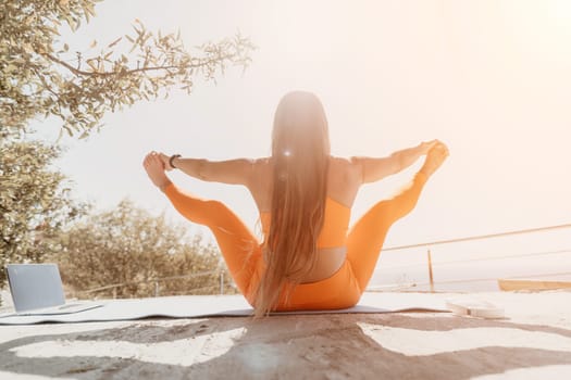 Fitness woman sea. Outdoor workout on yoga mat in park near to ocean beach. Female fitness pilates yoga routine concept. Healthy lifestyle. Happy fit woman exercising with rubber band in park.