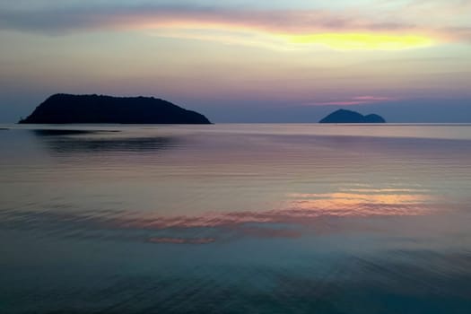 Amazing sunset with colorful clouds. Incredibly romantic sunrise on the beach. Ocean view. Tropical beach
