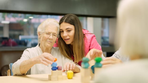 Photo of a nurse advising an old woman to resolve a skill game