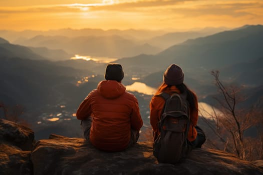 Asian couple in orange trekker outfit sitting on the rock and smile on mountain peak. Generative AI.