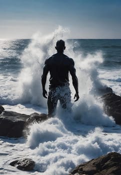 Silhouette of a man standing on the rocks in the sea.wave splash.human silhouette on the rocks on the seashore. Waves splashing on the rocks.