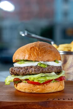 Lamb burger. Hamburger made with lamb meat. Classic traditional Greek variation of the classic American burger tradition. seasoned lamb meat with feta cheese, red onion, cucumbers and Greek mayo.