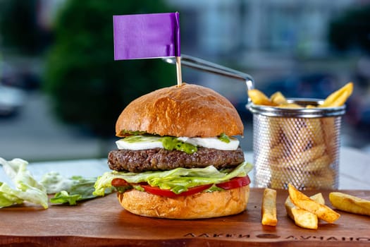 Lamb burger. Hamburger made with lamb meat. Classic traditional Greek variation of the classic American burger tradition. seasoned lamb meat with feta cheese, red onion, cucumbers and Greek mayo.