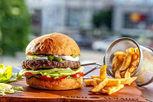 Lamb burger. Hamburger made with lamb meat. Classic traditional Greek variation of the classic American burger tradition. seasoned lamb meat with feta cheese, red onion, cucumbers and Greek mayo.