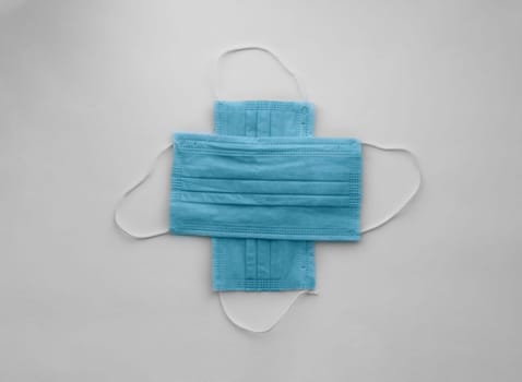 medical protective masks cross shape on white with copy space