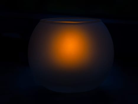 Frosted glass candlestick with a burning candle