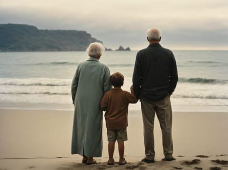 An older couple and a young boy happily stand on a sandy beach, basking in the joy of spending quality time together.