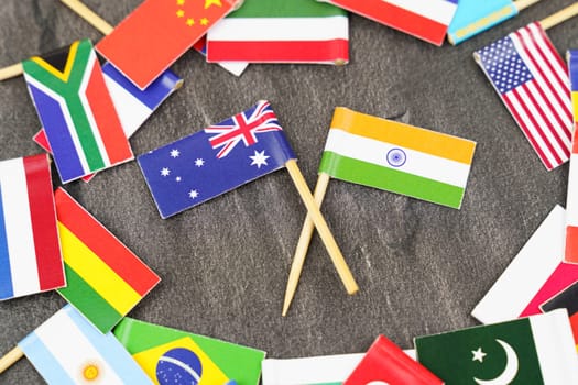Policy. National flags of different countries. The concept is diplomacy. In the middle among the various flags are two flags - India, Australia