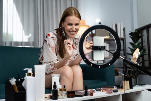 Woman influencer shoot live streaming vlog video review makeup utmost social media or blog. Happy young girl with cosmetics studio lighting for marketing recording session broadcasting online.