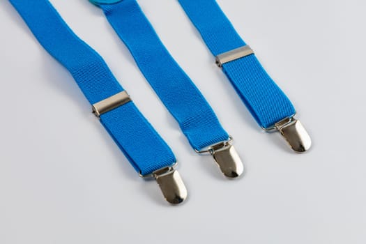 Small and blue trousers suspenders made of elastic fabric