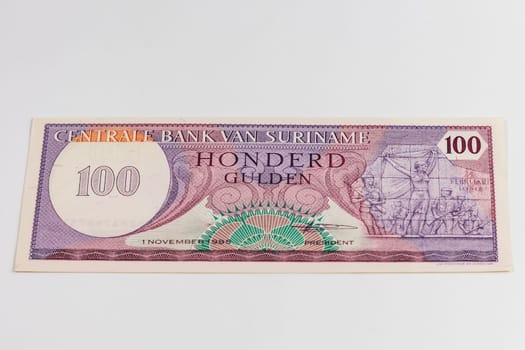 Old Suriname banknote of 100 Gulden from 1985 year 