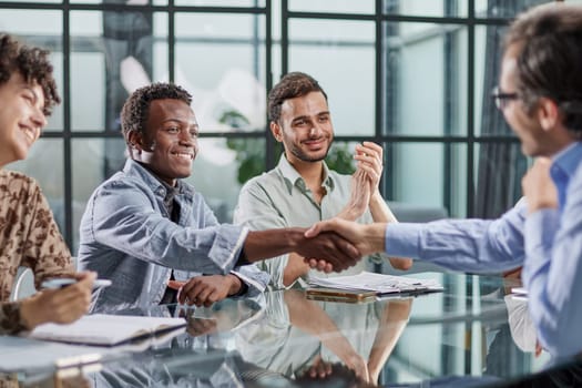 handshake during a successful meeting in modern office